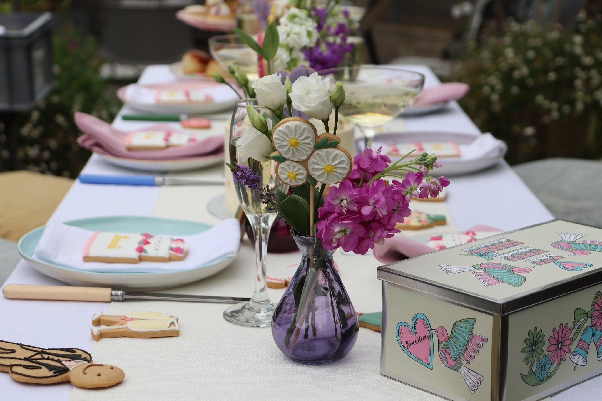 Hand-iced wedding biscuits by Biscuiteers, perfect for personalised gifts and unique wedding favours, beautifully displayed.