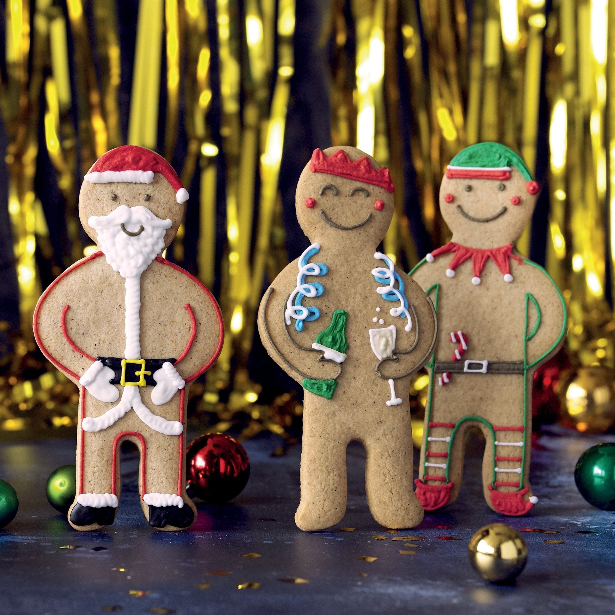 Jolly Ginger Christmas biscuits with festive streamers, perfect for Biscuiteers' personalised holiday gifts and secret Santa ideas.