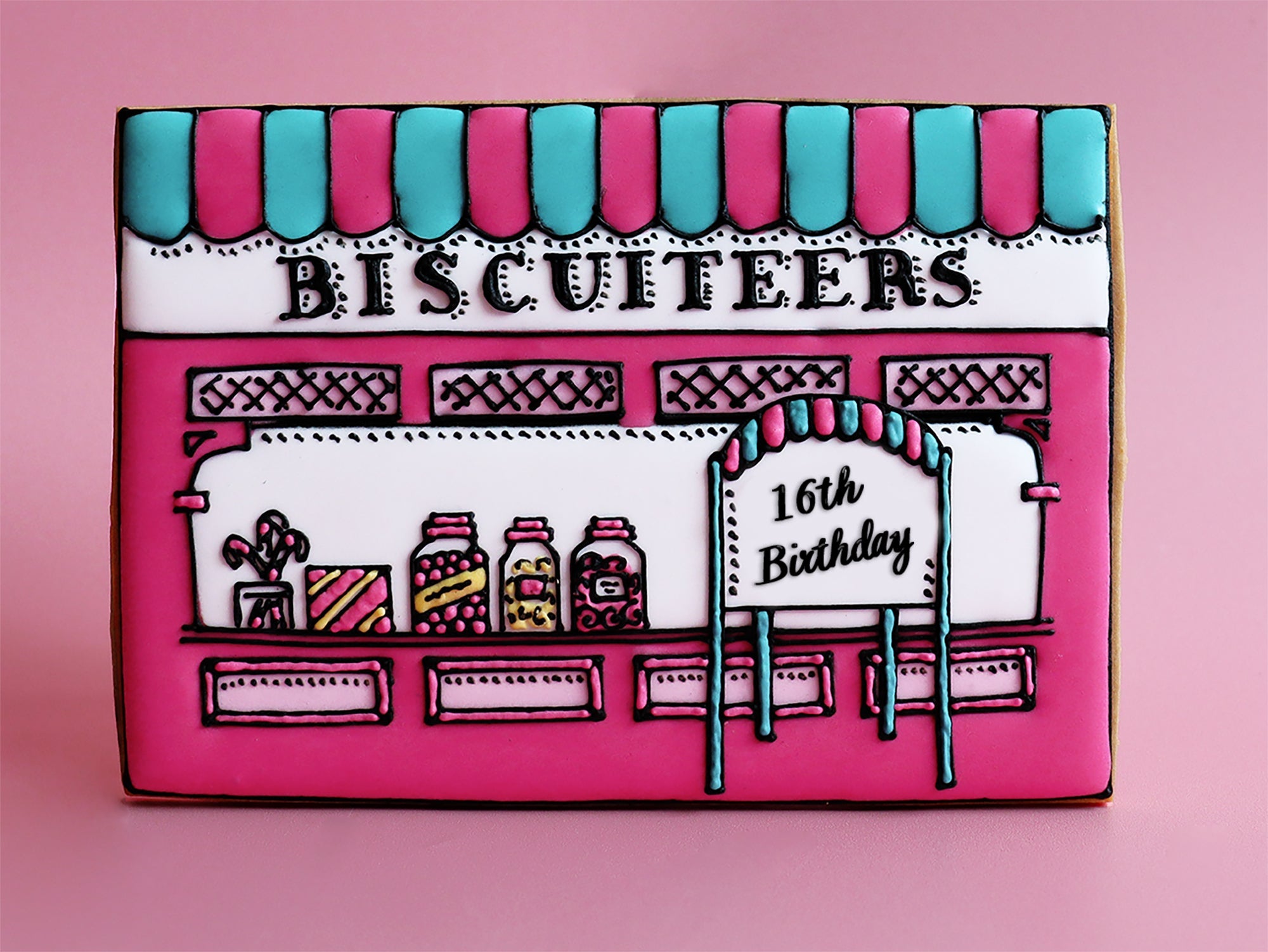 Sweet shop-themed biscuits by Biscuiteers, celebrating 16 years of hand-iced, personalised gifts for every occasion.