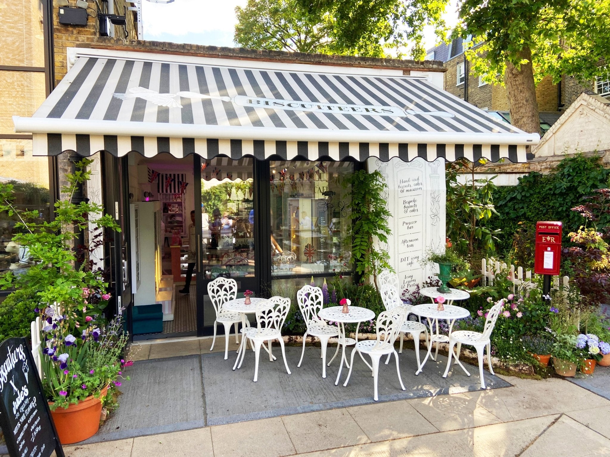 Biscuiteers Belgravia boutique adorned with vibrant spring flowers by Wild at Heart, celebrating the Queen's Platinum Jubilee.