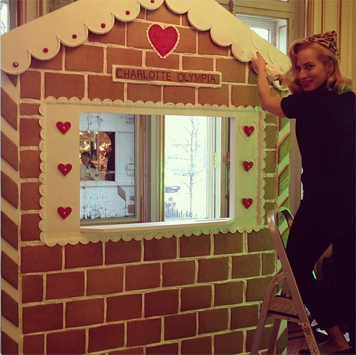 Life-size gingerbread house by Biscuiteers for Charlotte Olympia's Paris Fashion Week, perfect for personalized gifts.