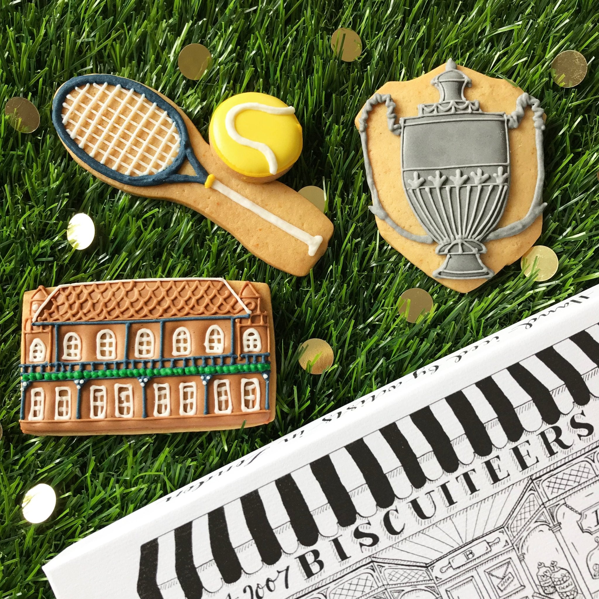 Bespoke tennis-themed biscuits by Biscuiteers for Lawn Tennis Association, featuring rackets, balls, and Queens Park Pavilion.