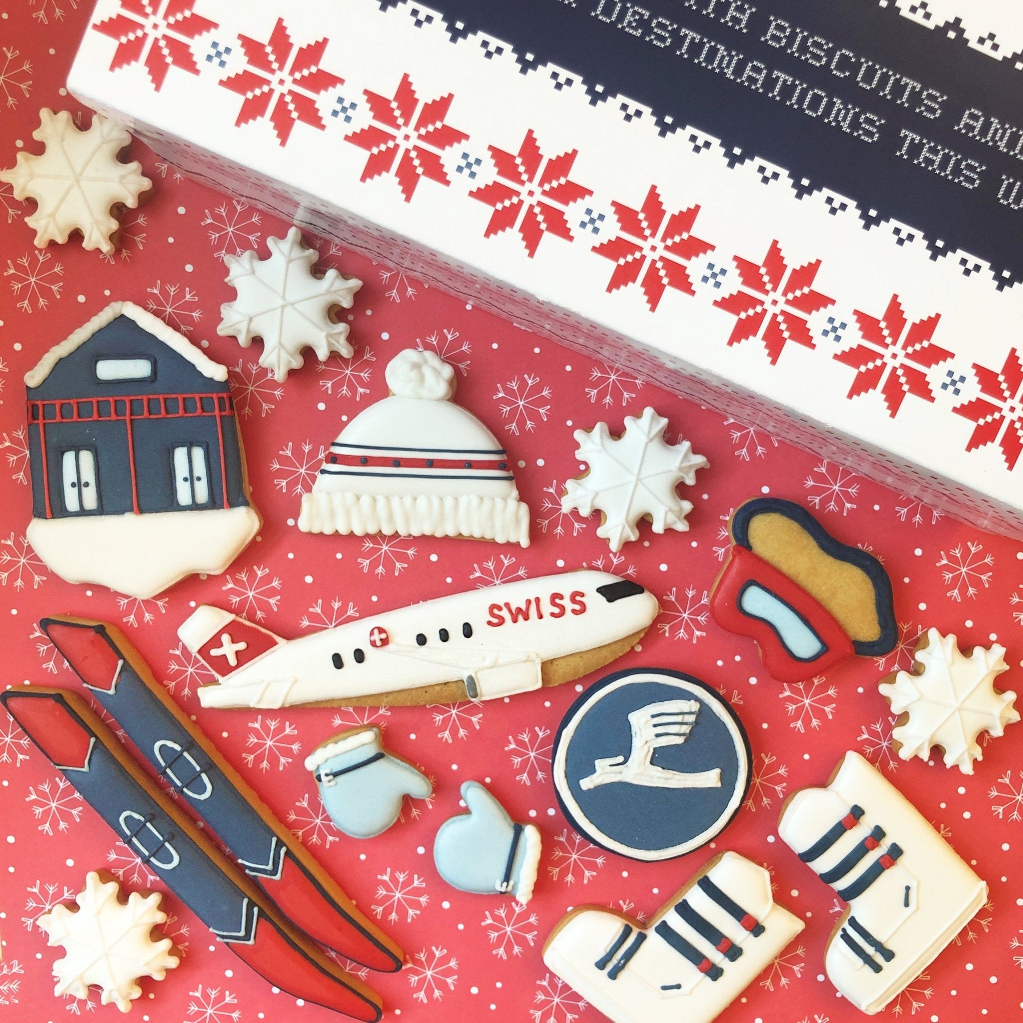 Swiss Airlines and Lufthansa branded Christmas biscuits by Biscuiteers, featuring snow and ski designs for corporate gifting.
