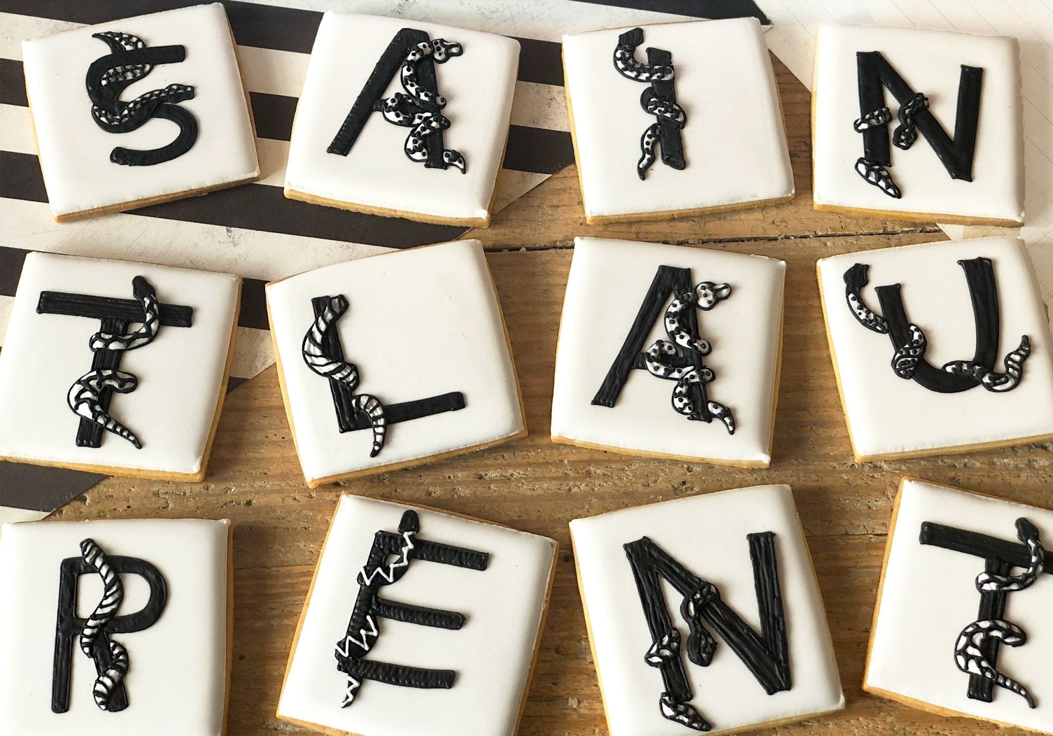 Saint Laurent x Biscuiteers collaboration: bespoke tins with themed biscuits for Rive Droite store.