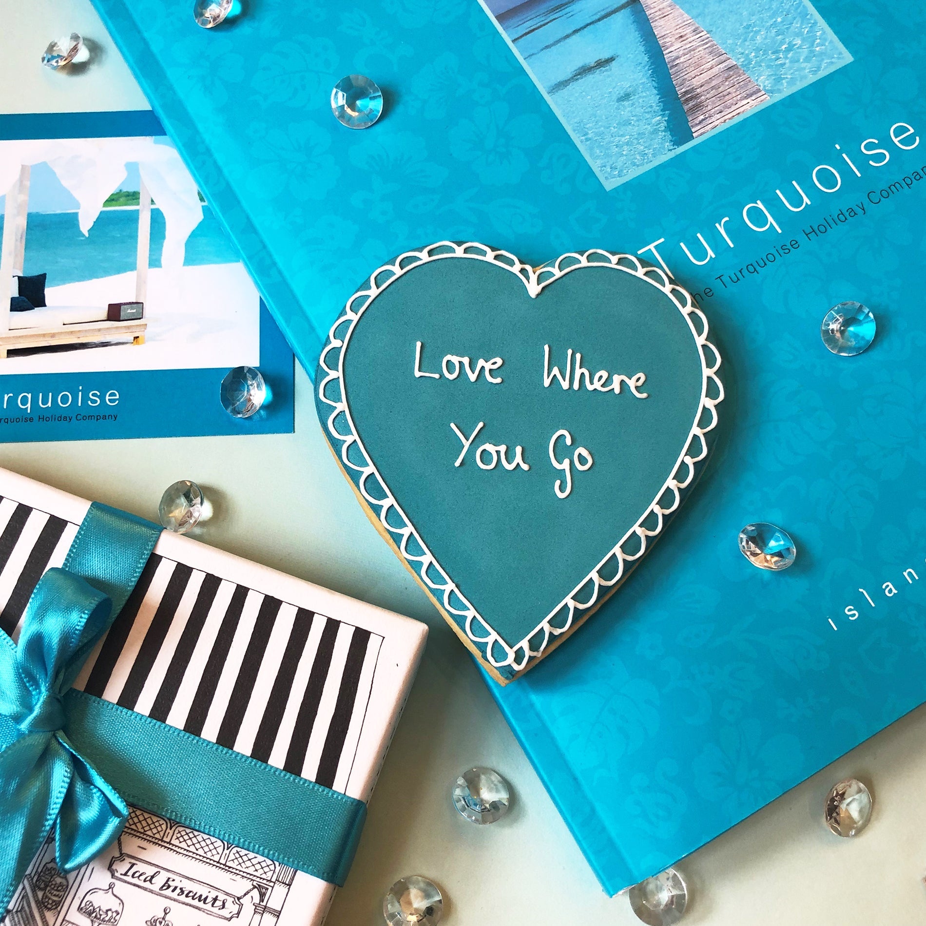 Bespoke biscuit gift in hand-illustrated box with turquoise ribbon by Biscuiteers for Turquoise Holiday Company.