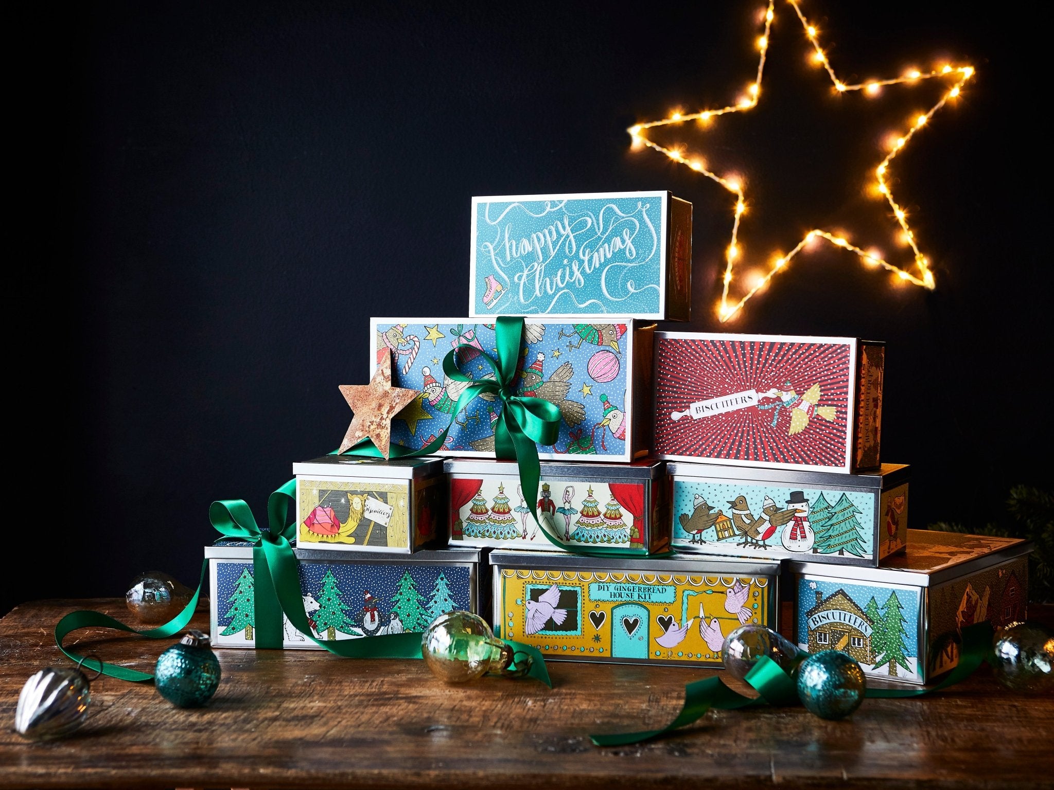 Biscuiteers Christmas gift tins with festive biscuits, chocolates, and personalized treats for the holiday season.