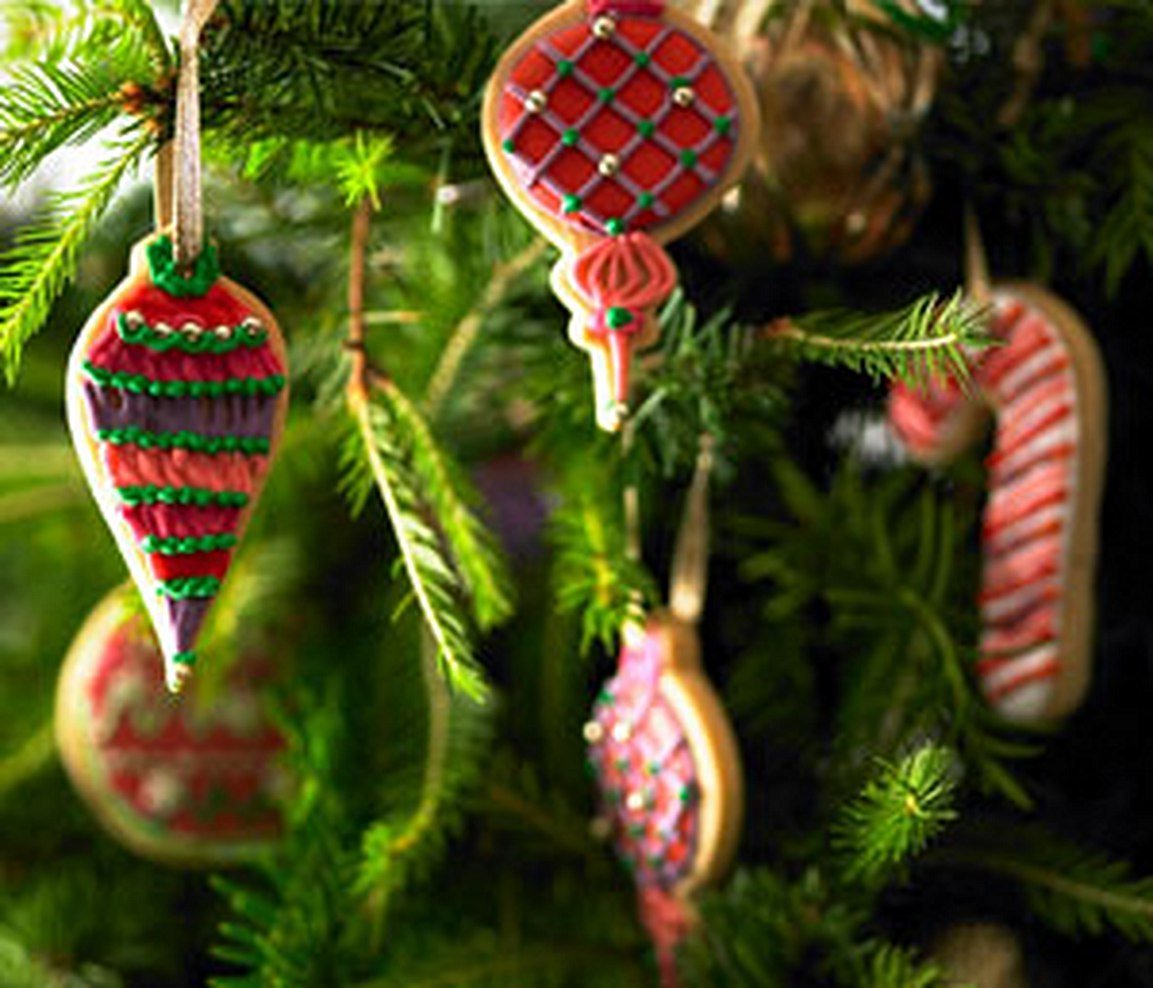Festive Christmas baubles with intricate icing designs, perfect for personalized gifts from Biscuiteers this holiday season.