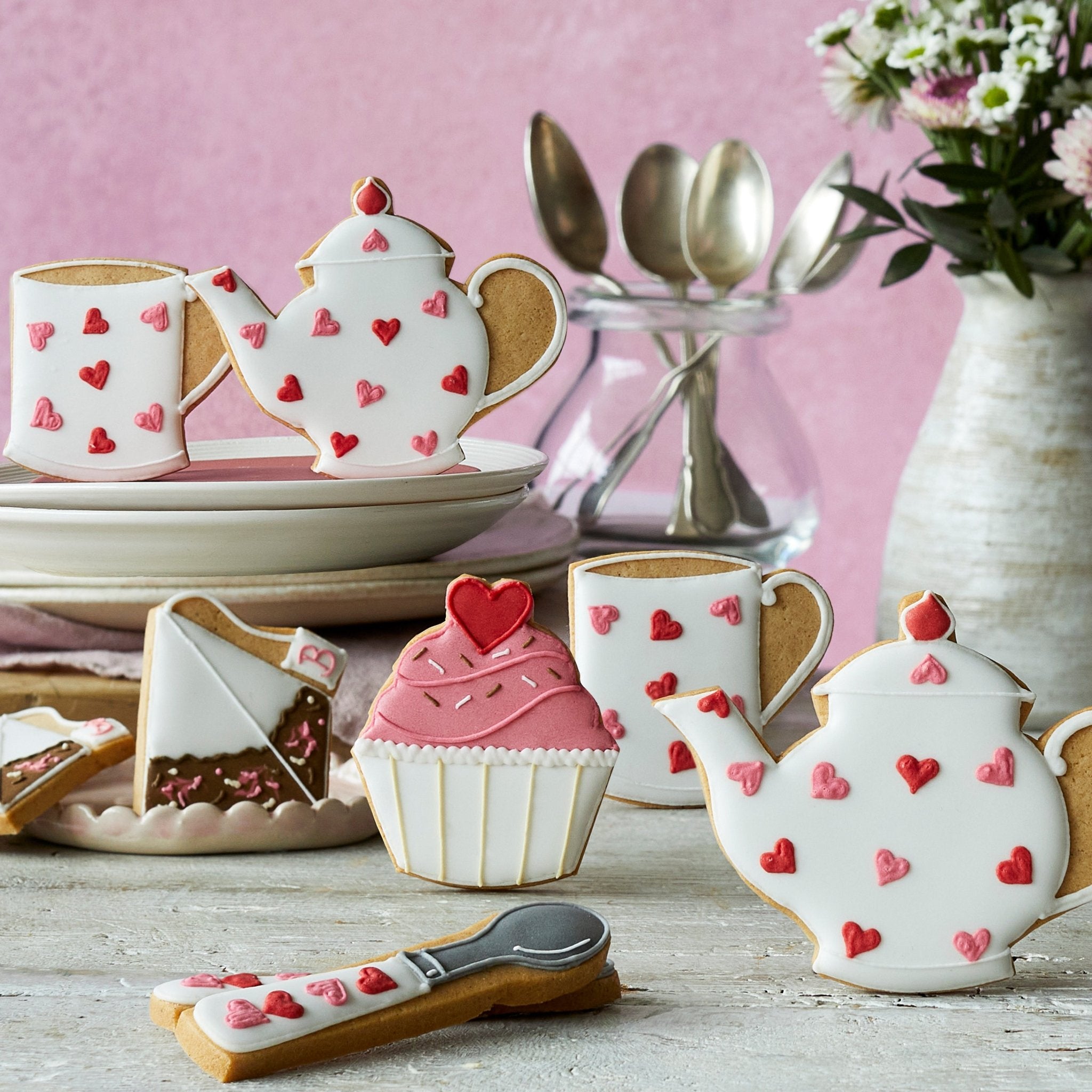Hand-iced Biscuiteers biscuits in Emma Bridgewater's pink heart design, perfect for Mother's Day personalized gifts.
