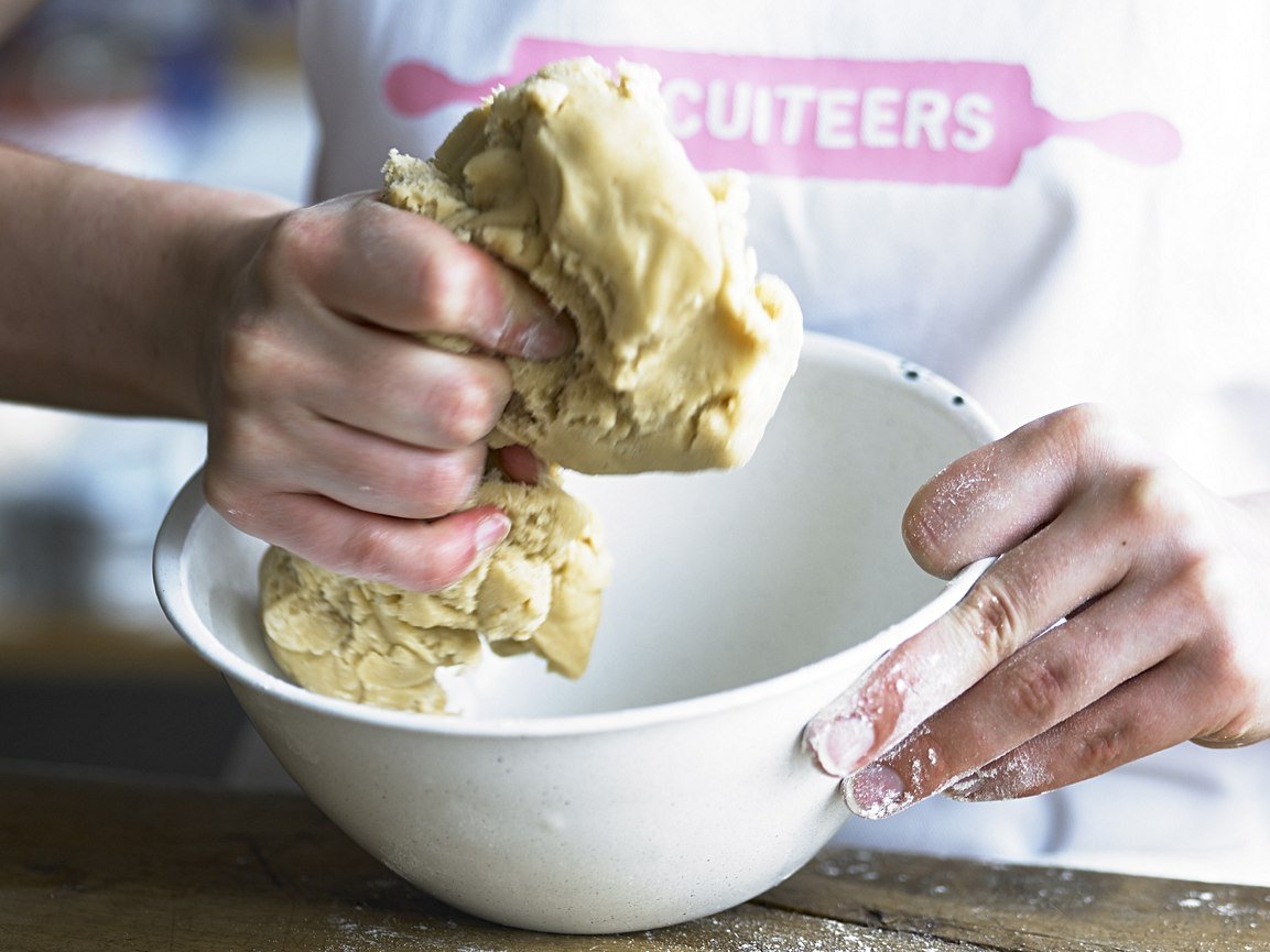 Biscuiteers kitchen with steel tables, mixers, and equipment for making biscuit dough; perfect for personalized gifts.