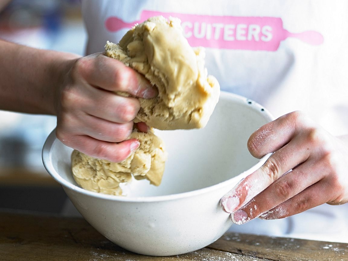 Biscuiteers kitchen with steel tables, mixers, and baking tools for creating personalized biscuit gifts effortlessly.