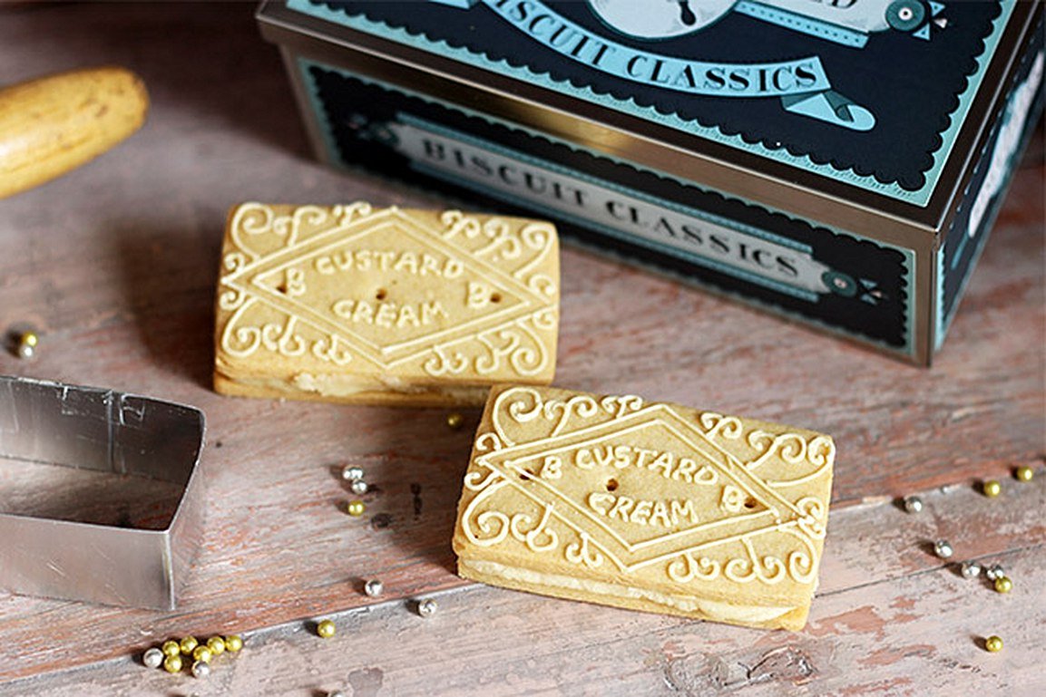 Biscuiteers beach-themed dining setup with custard cream biscuits, perfect for summer gatherings and personalized gifts.