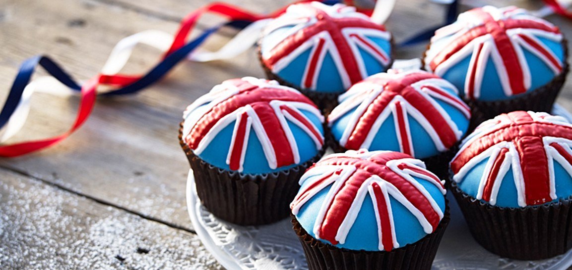 Union Jack cupcakes with fondant icing, perfect for Queen's 90th birthday celebrations by Biscuiteers, personalized gifts.