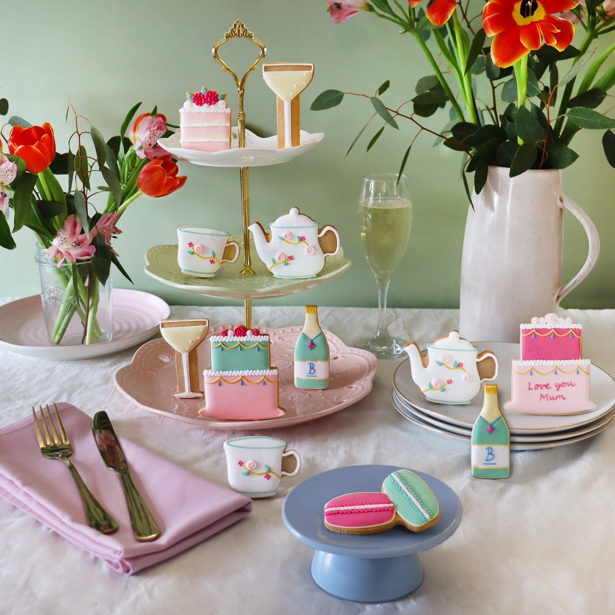Mother's Day tea set with Biscuiteers biscuits, floral teapot, and cups, perfect for a personalized afternoon celebration.