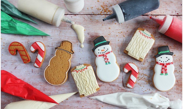 Hand-iced Christmas biscuits from Biscuiteers' holiday collection, perfect for festive personalized gifts and cozy winter days.