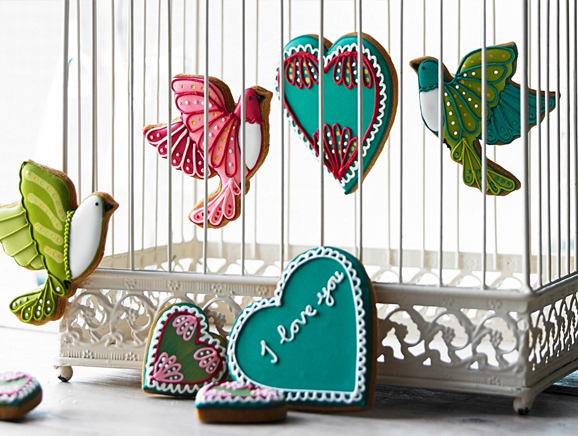 Valentine's Day love bird biscuits with intricate icing details, perfect for personalized gifts from Biscuiteers.