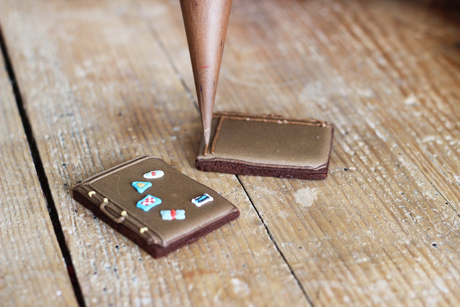 Vintage Traveller Biscuit Tin with suitcase and compass designs, perfect for world travellers and personalised gifts by Biscuiteers.