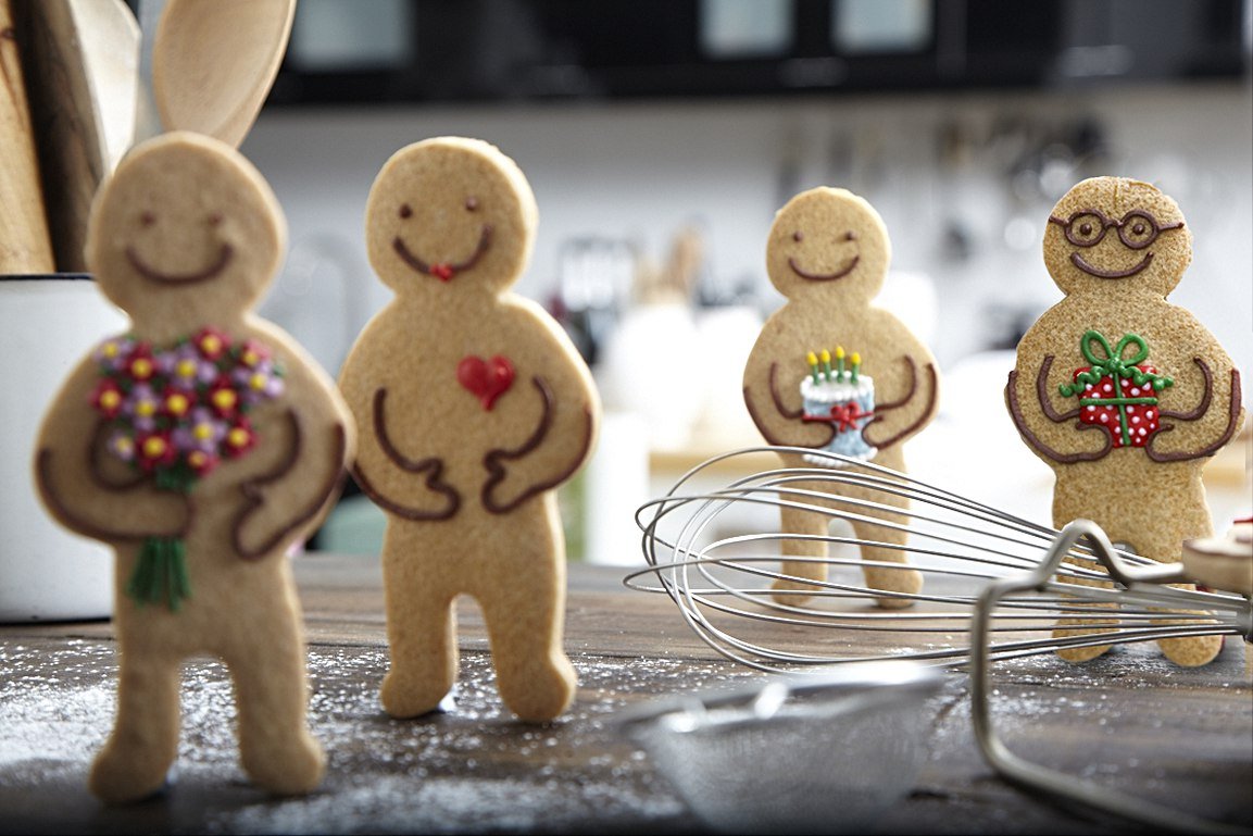 Jolly Gingerbread Men with colorful icing, perfect for festive occasions, personalized gifts, and Biscuiteers' creative baking.