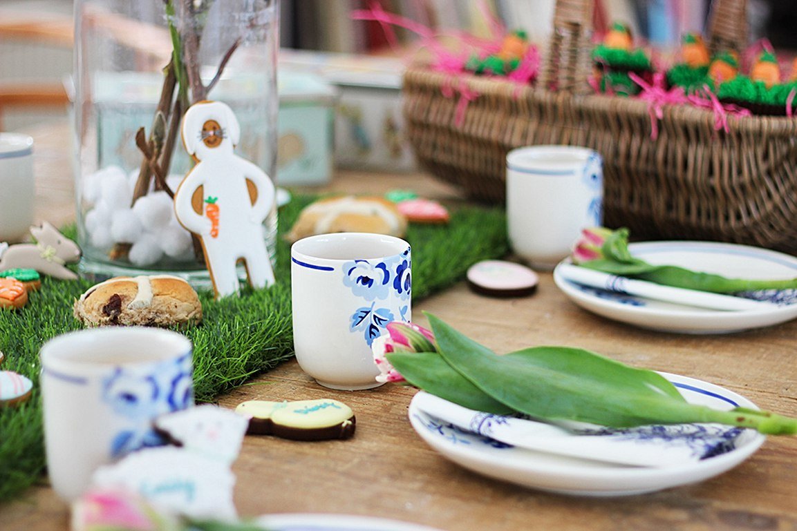Easter-themed table setting with Biscuiteers biscuits, personalized name icing, and Cath Kidston tableware for festive decor.