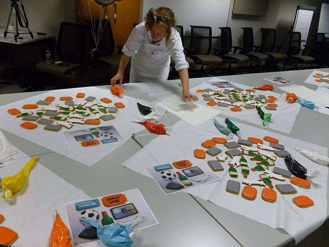 Biscuiteers icing lesson at Amex for Centurion card re-launch, featuring personalized biscuits as unique gifts.