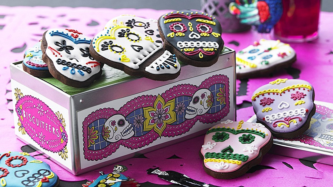 Colorful sugar skull biscuits for Halloween by Biscuiteers, perfect for Day of the Dead celebrations and personalized gifts.
