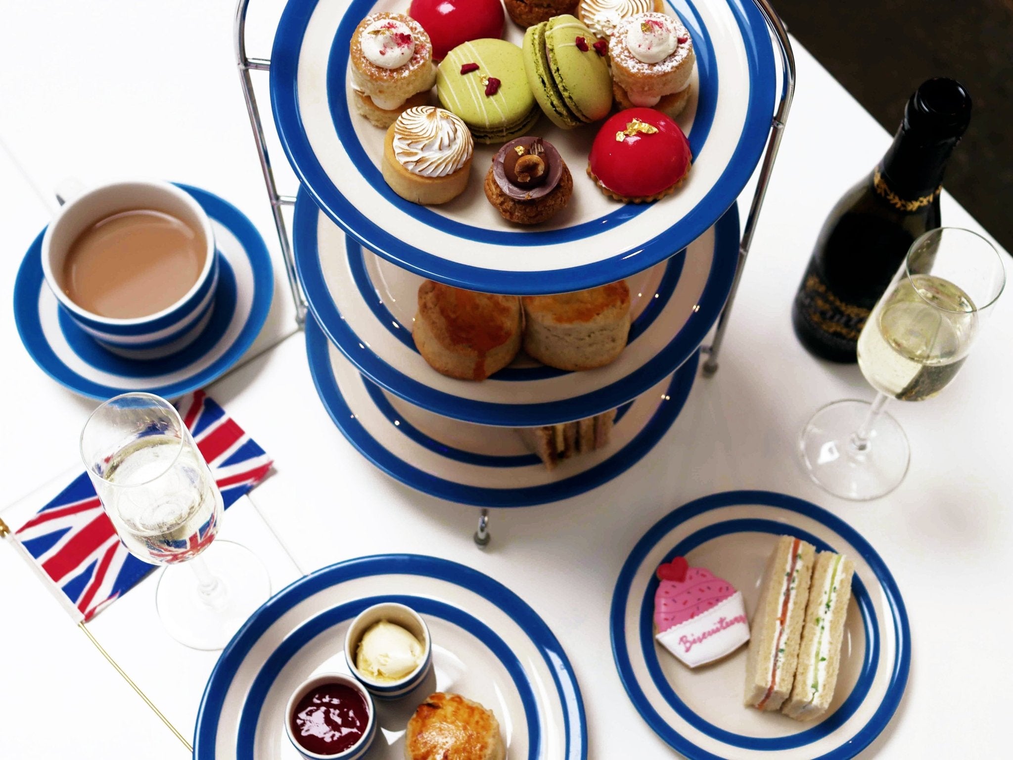 Afternoon tea set with Biscuiteers' hand-iced biscuits, scones, and tea, perfect for a unique London tea experience.