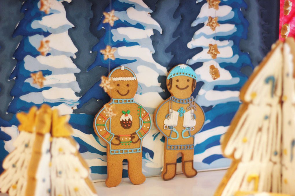Biscuiteers Christmas window display with iced biscuits, creating festive magic and personalized gift inspiration.