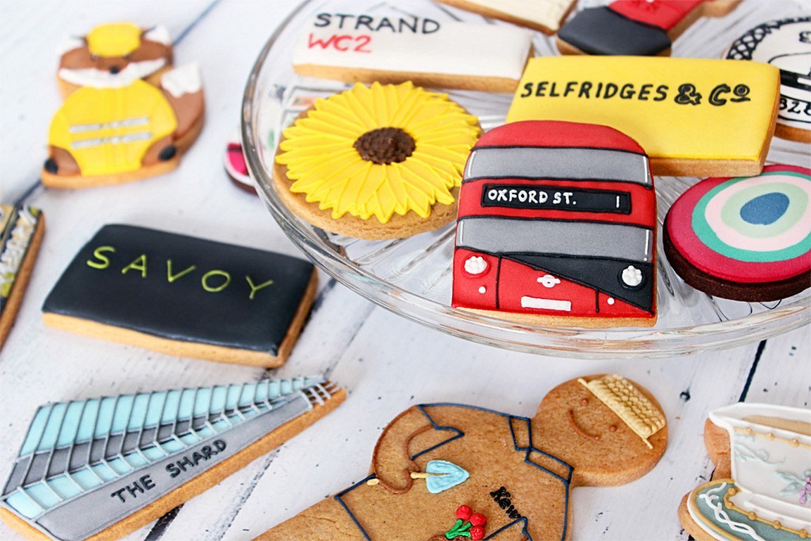Bespoke Biscuiteers biscuits for The Savoy, featuring hand-illustrated tin stickers, perfect for personalised gifts.